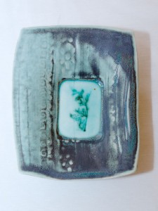 Porcelain dropped plate with celadon and copper reduction glaze