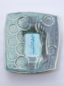 Porcelain dropped plate with duck egg shino and copper glaze