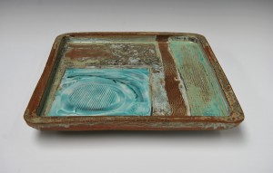 Large square stoneware tray with porcelain slip and copper glazes.
