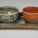 Wide oblong stoneware tray with porcelain bowls.
